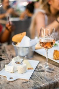 image of wine in glass and selection of cheeses