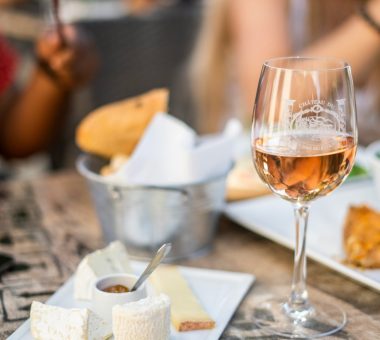 image of wine in glass and selection of cheeses