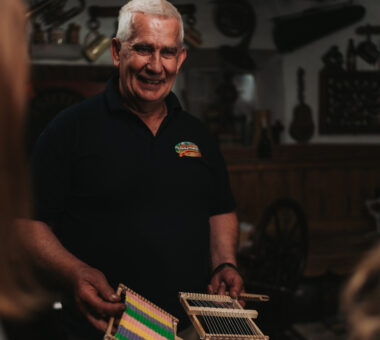 Colin Winter with a handheld weaving loom at Dan Winter's Cottage