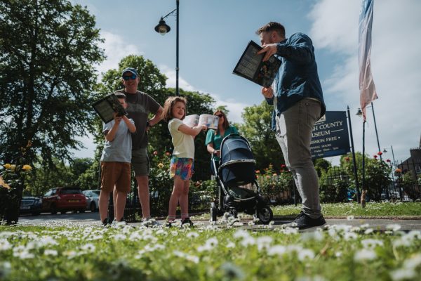 Jonathan Hackett taking a family on a guided tour
