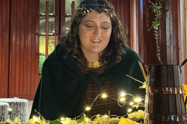 image of woman in costume gazing at light arrangement