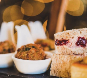 Assorted afternoon tea items including sandwiches, savoury bites, and small desserts on display.