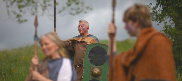 Image depicts Celtic Warriors in traditional dress holding spheres and one holding a shield.