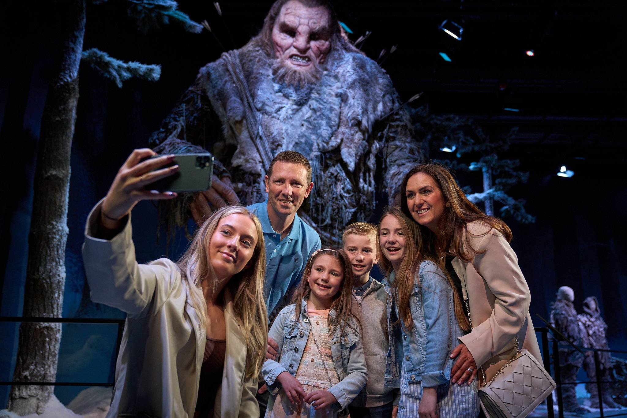 GOTst Group taking a selfie in front of a large creature display at the Game of Thrones Studio Tour.