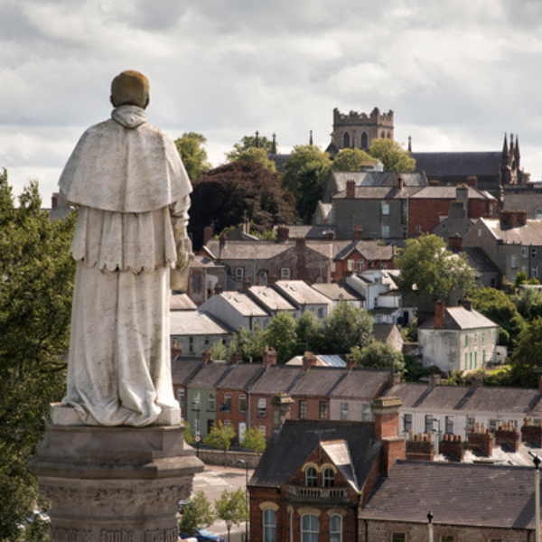 Pilgrim’s Passport Tour Stone statue outside St Patrick’s Roman Catholic Cathedral overlooking Armagh city toward St Patrick’s Church of Ireland Cathedral.