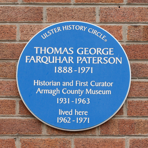 The Blue Plaque Tour Blue plaque on a brick wall commemorating Thomas George Farquhar Paterson, historian and first curator of Armagh County Museum.