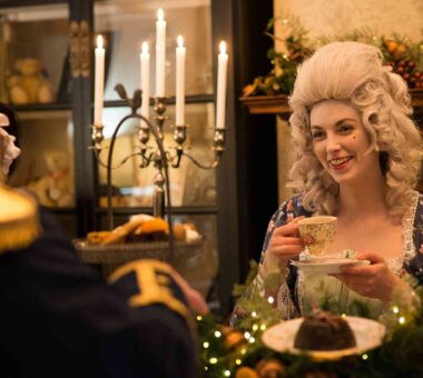 Georgian character in conversation, holding a tea cup