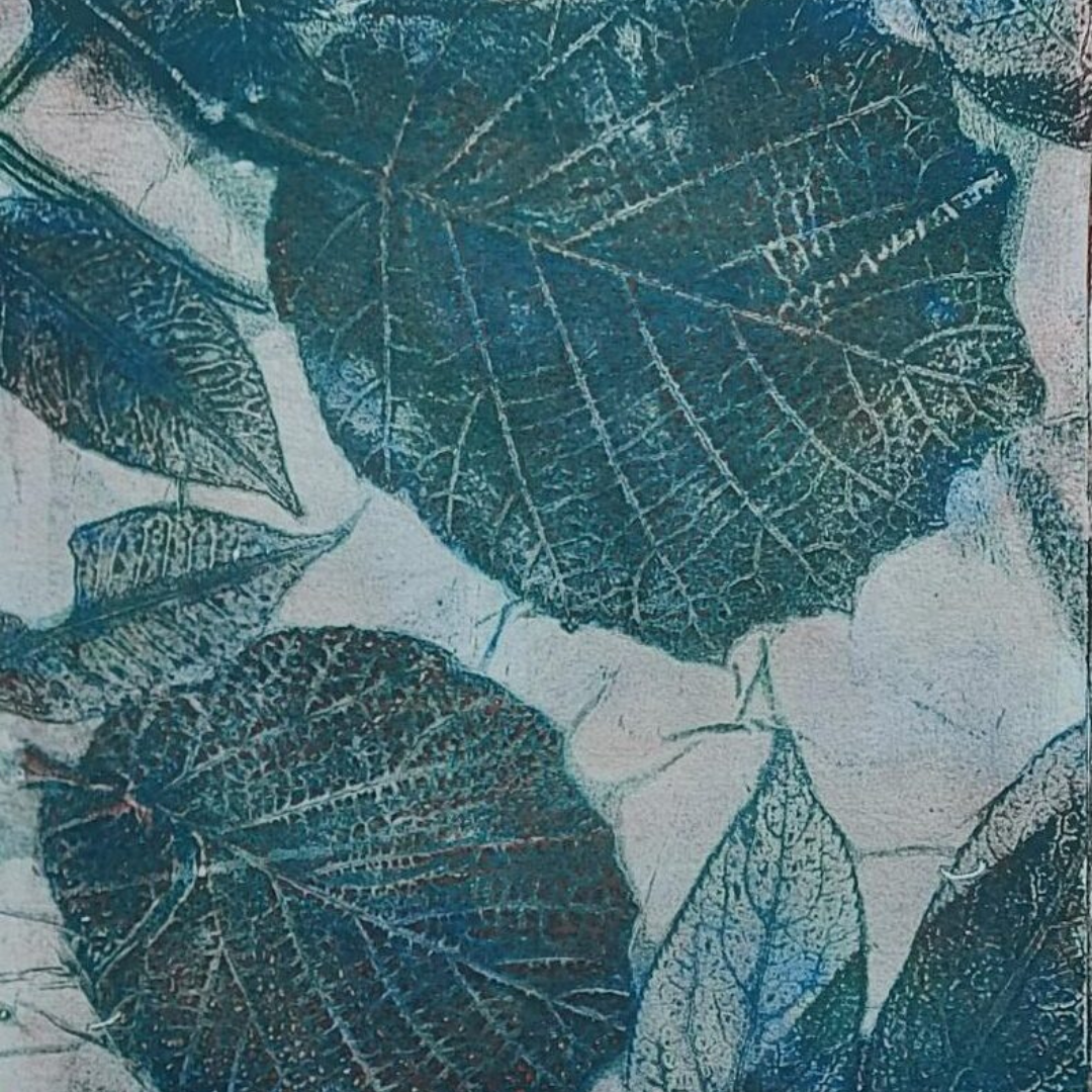 Botanical eco-print featuring detailed leaf impressions in shades of blue and teal, showcasing natural textures and vein patterns from leaves and flowers.