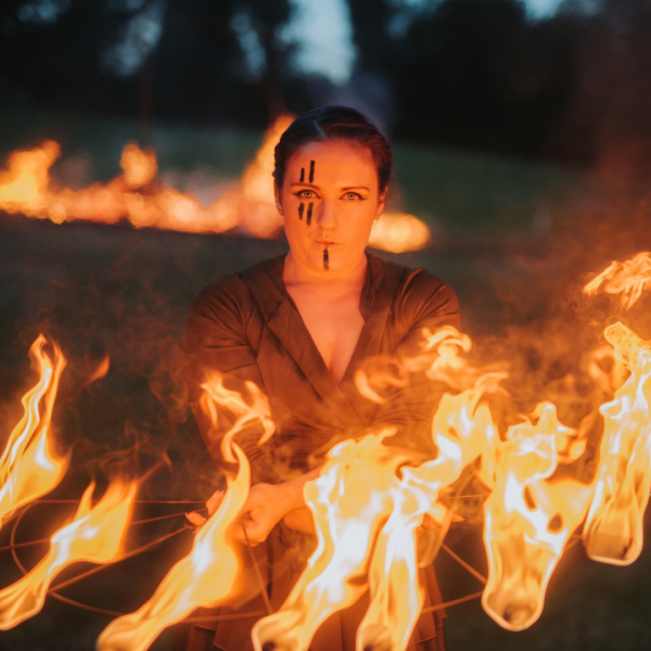 Fire performer surrounded by flames during a Samhain-themed event at Navan Centre & Fort.
