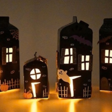 Haunted House Lanterns Halloween-themed paper lanterns shaped like haunted houses glowing with candlelight.